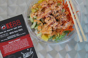 closeup of poke bowl beside Poke88 flyer