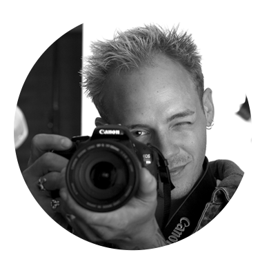 headshot of man holding camera