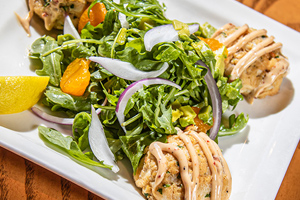 crab cakes and salad on white plate