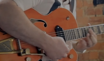 closeup of man playing electric guitar