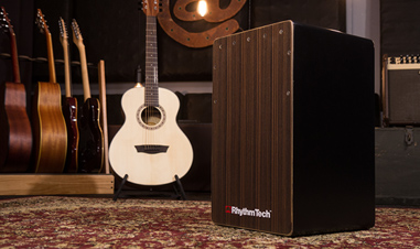 Rhythm tech cajon with multiple guitars in background