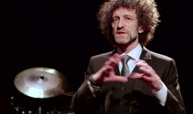 man in front of Sabian symbol