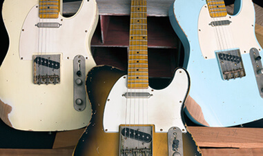 three Michael Kelly electric guitars
