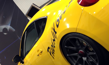 partial view of yellow sports car