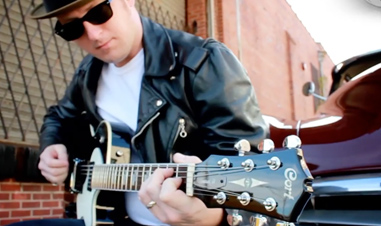 man playing Cort electric guitar